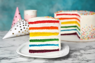 Photo of Delicious rainbow cake for party on table