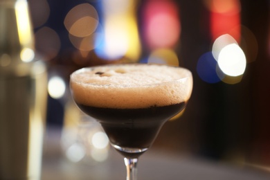 Photo of Glass of Espresso Martini with coffee beans in bar. Alcohol cocktail