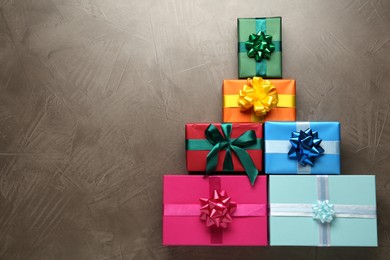 Photo of Many colorful gift boxes on grey table, flat lay. Space for text