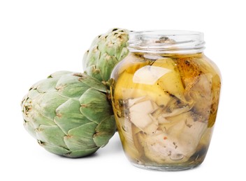 Photo of Open jar of delicious artichokes pickled in olive oil and fresh vegetables on white background
