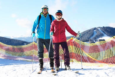 Couple spending winter vacation at mountain ski resort