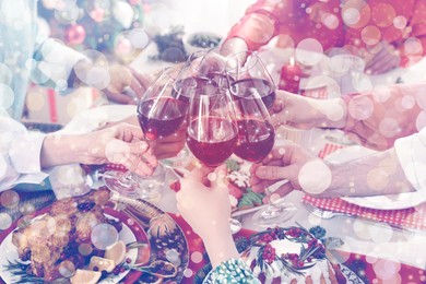 Image of Family with their friends clinking glasses at festive dinner indoors, closeup. Christmas Eve celebration