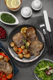 Photo of Tasty beef tongue pieces with potatoes and ingredients on grey table, flat lay
