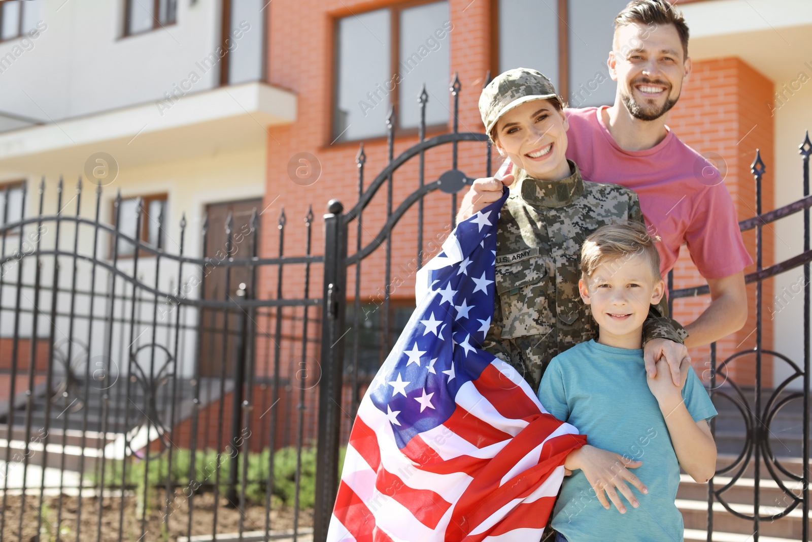 Photo of American soldier with her family outdoors. Military service
