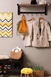 Photo of Hallway interior with stylish furniture, clothes and accessories