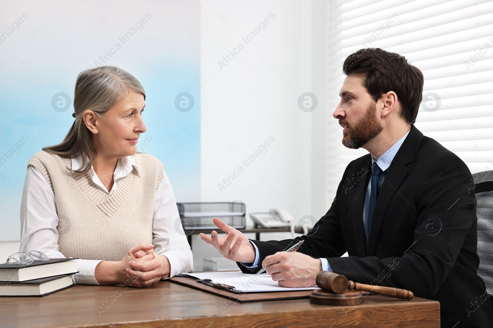 Photo of Senior woman having meeting with lawyer in office