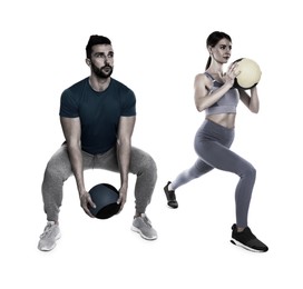 Athletic couple doing exercise with medicine balls on white background