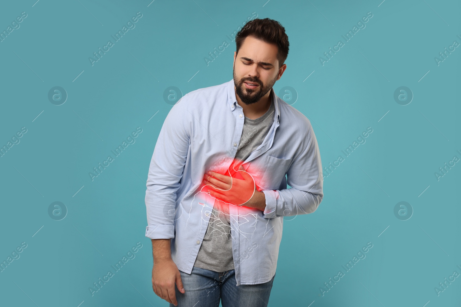 Image of Man suffering from stomach ache on light blue background. Illustration of unhealthy gastrointestinal tract