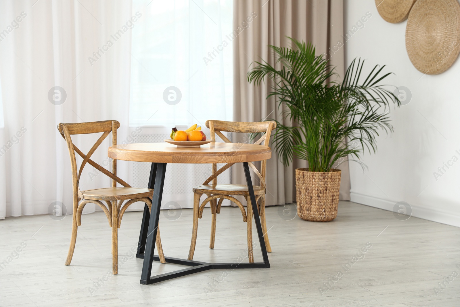 Photo of Stylish room interior with dining table and chairs