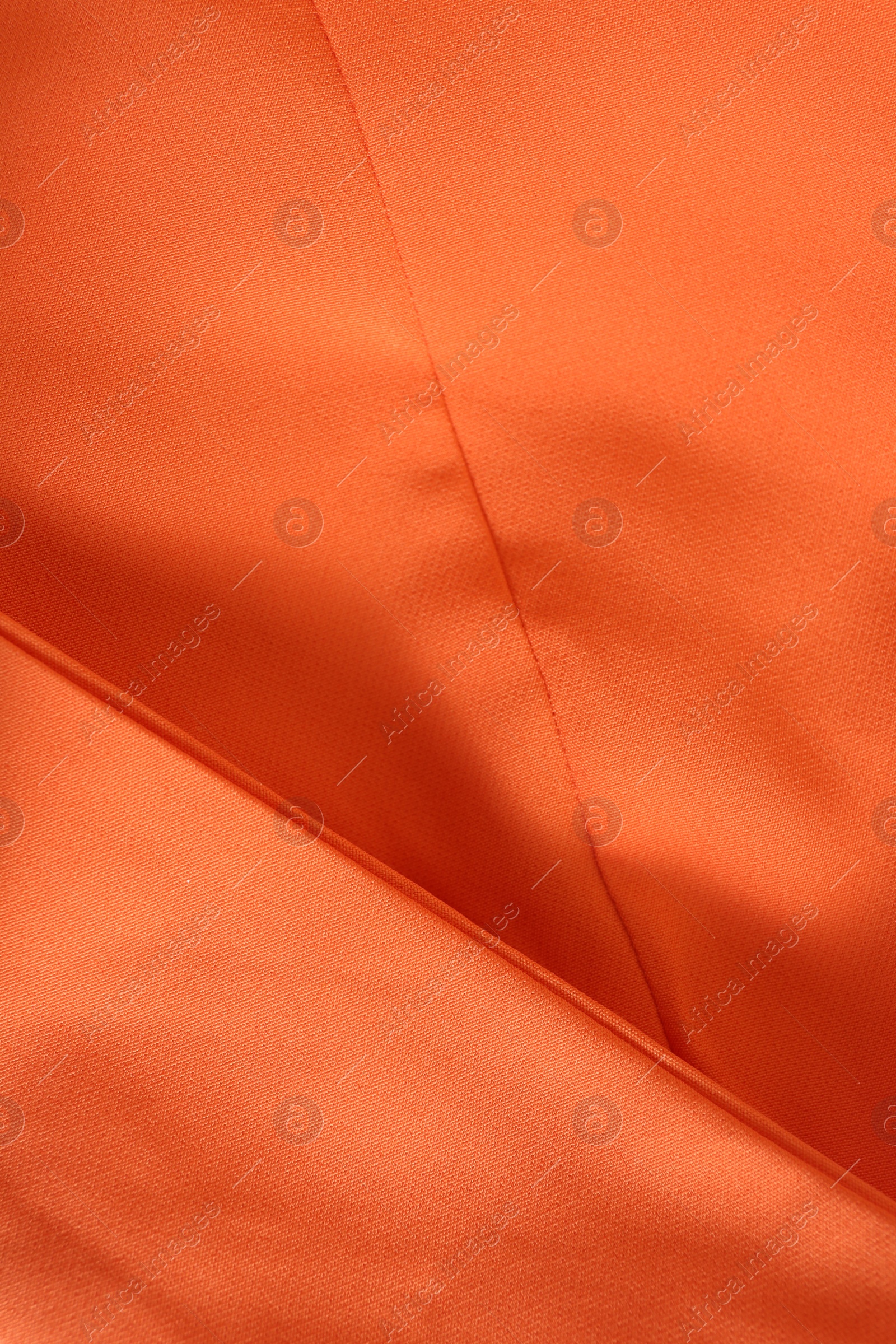 Photo of Texture of orange fabric as background, closeup