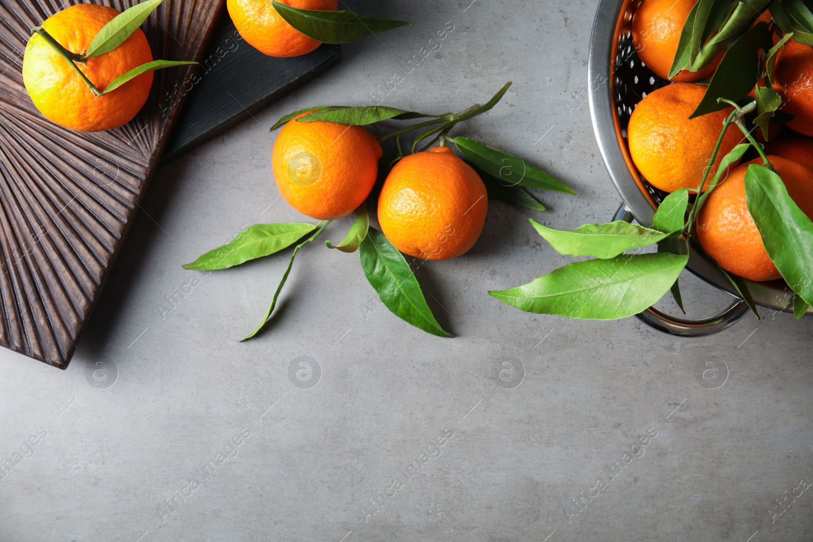 Photo of Flat lay composition with ripe tangerines on grey background. Space for text