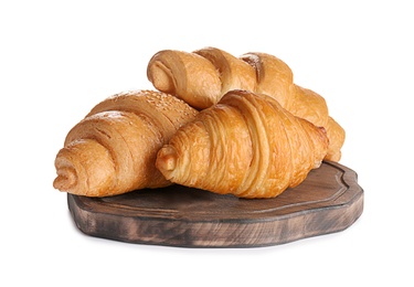 Wooden board with tasty croissants on white background