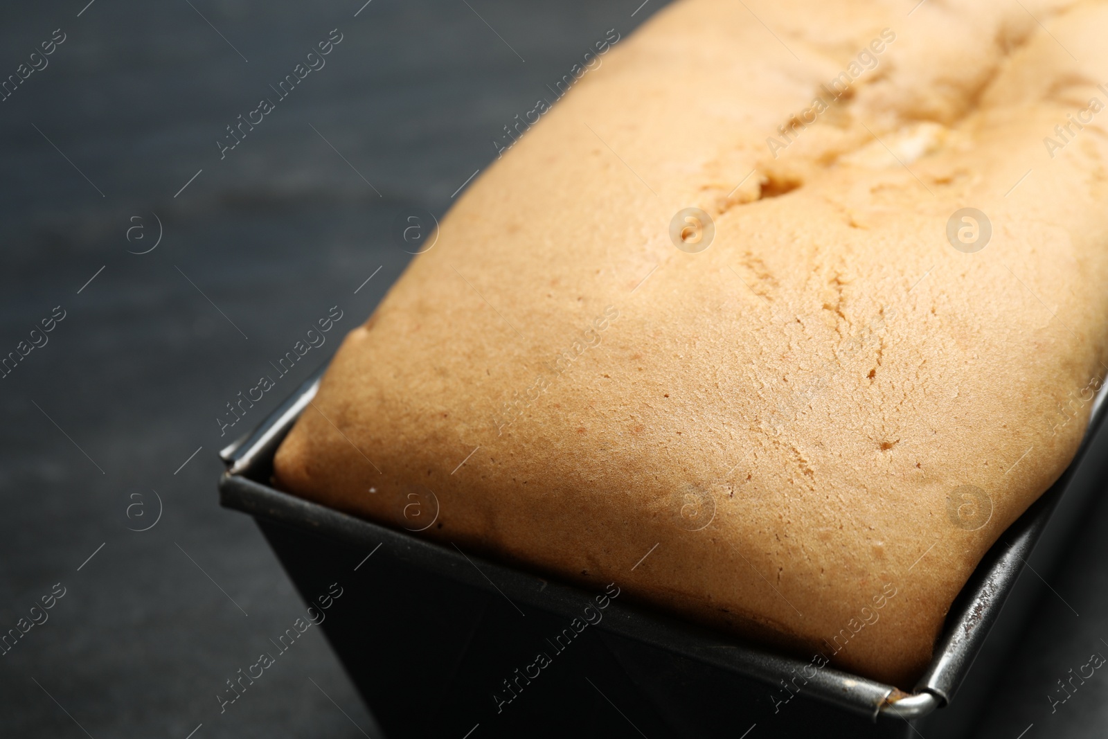 Photo of Tasty pear bread on black table, closeup. Homemade cake