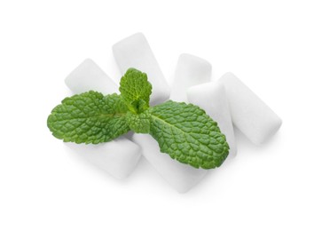 Heap of chewing gum pieces and mint on white background, top view