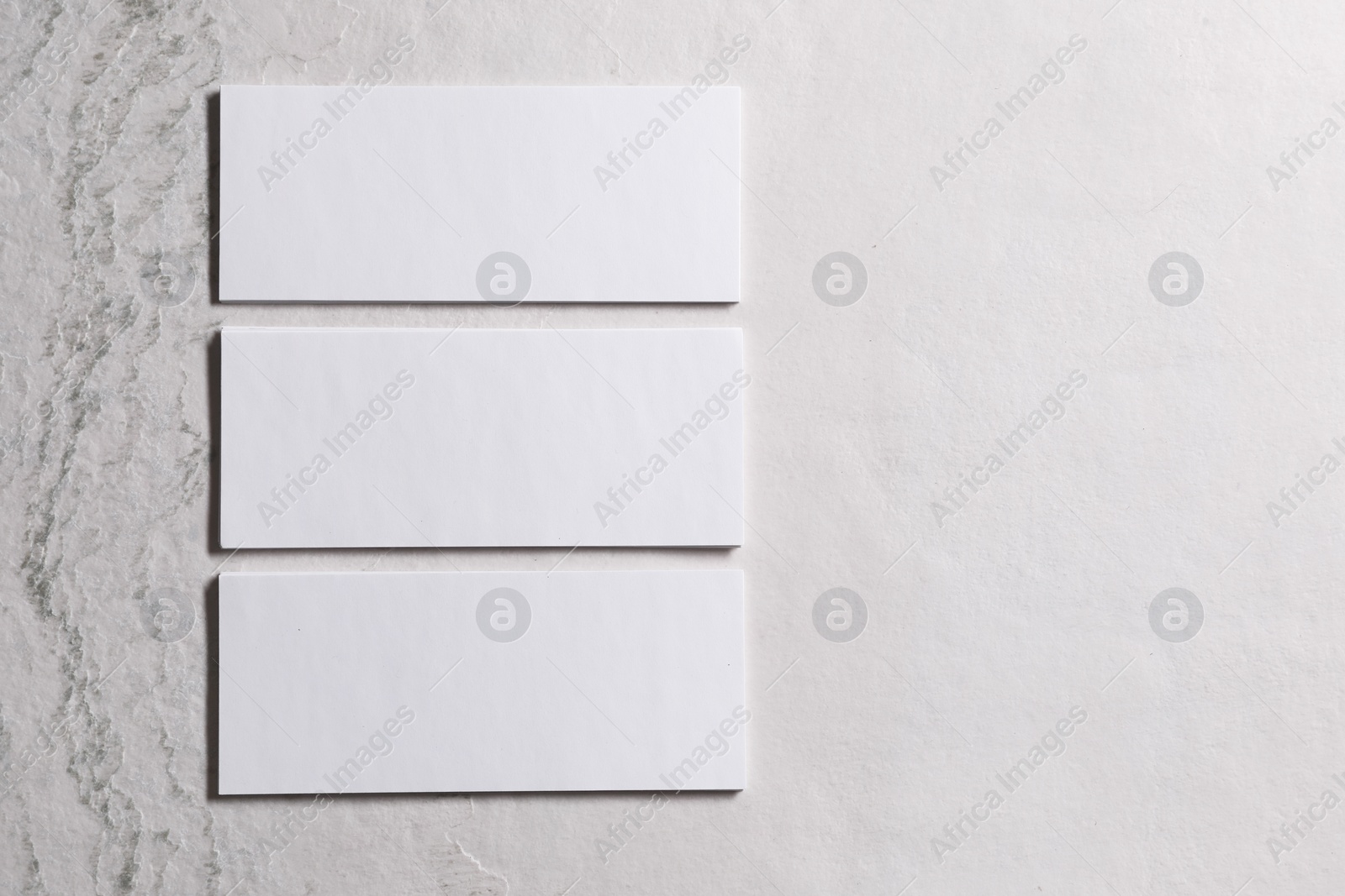 Photo of Blank business cards on beige textured background, top view. Mockup for design