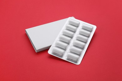 Photo of Blister with chewing gums on red background