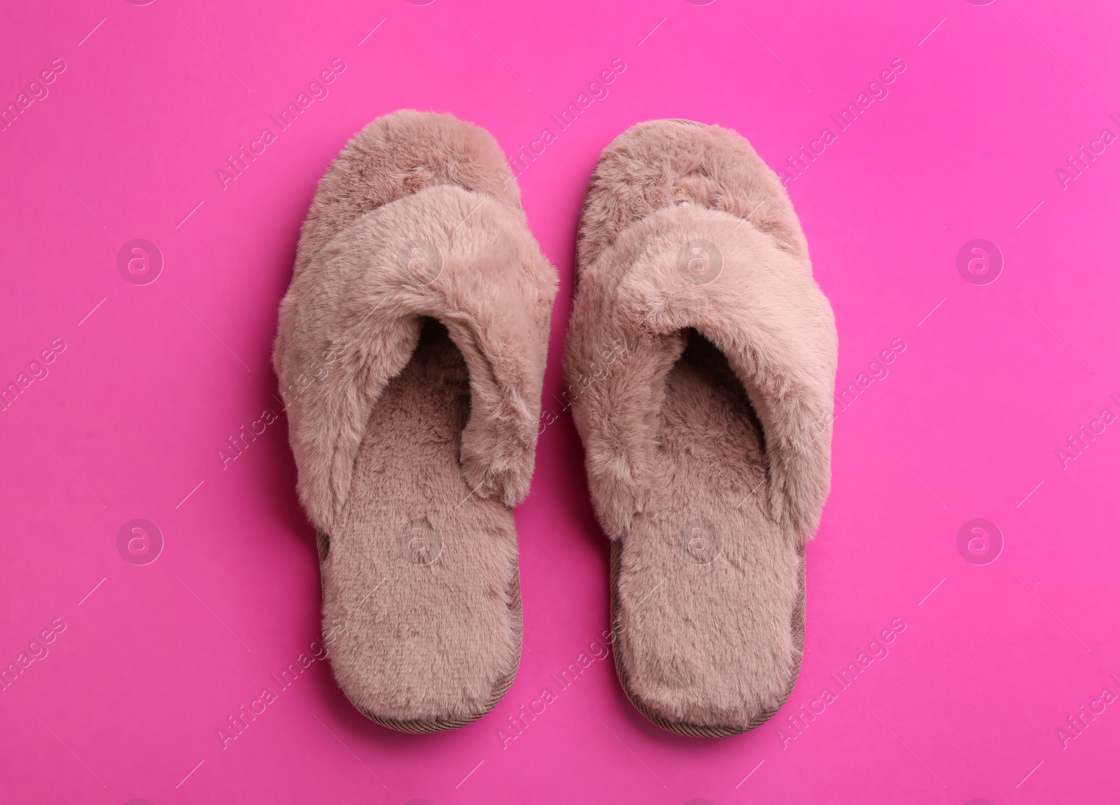 Photo of Pair of stylish soft slippers on pink background, flat lay