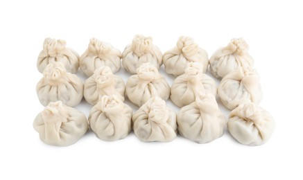 Photo of Many tasty khinkali (dumplings) isolated on white. Georgian cuisine