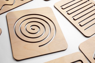 Wooden finger labyrinths on white background. Montessori toy