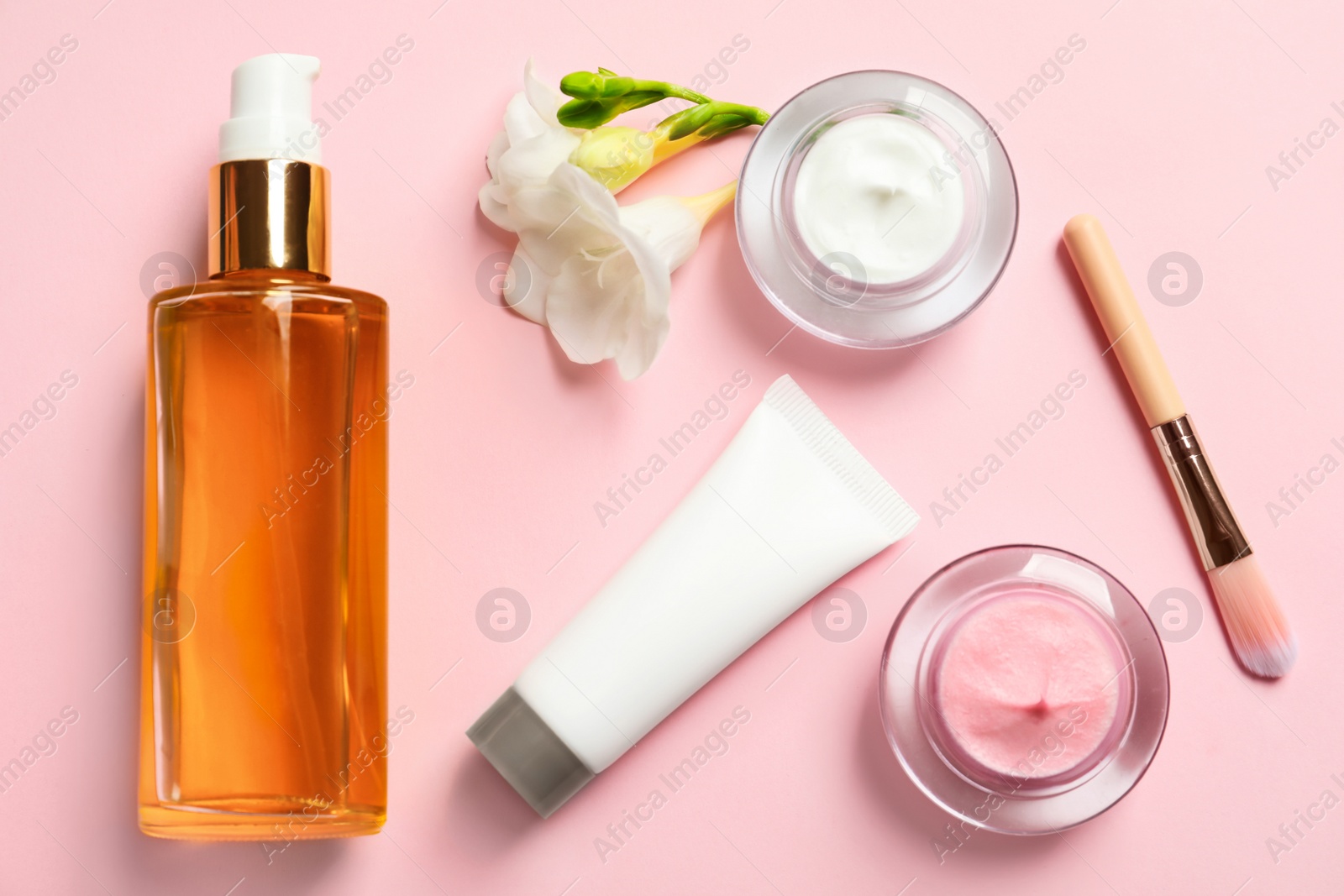 Photo of Flat lay composition with cosmetic products on color background