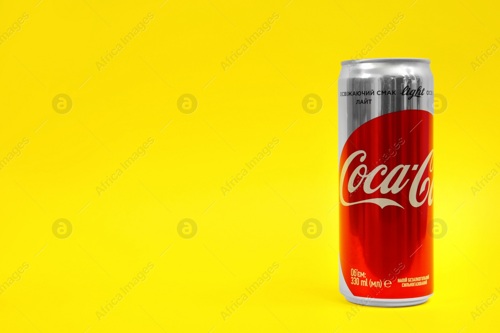 Photo of MYKOLAIV, UKRAINE - NOVEMBER 14, 2018: Coca-Cola can on color background. Space for text