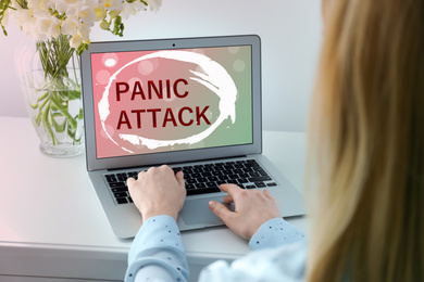 Image of Woman working with laptop at home. Use information safely to avoid panic attack