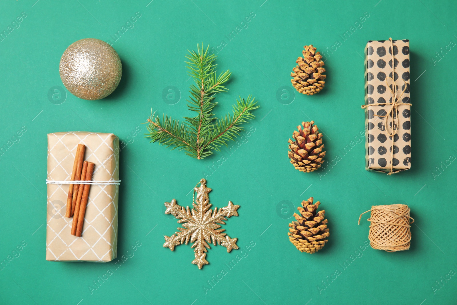 Photo of Flat lay Christmas composition with gift boxes and festive decor on color background