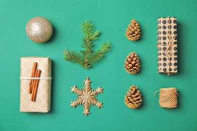 Photo of Flat lay Christmas composition with gift boxes and festive decor on color background