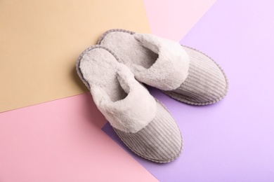 Pair of soft slippers on color background, flat lay