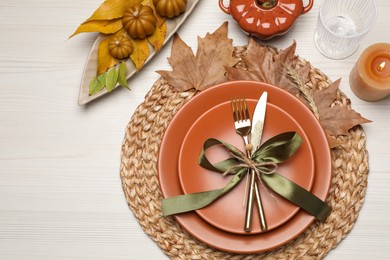 Photo of Beautiful place setting with autumn decor on white wooden table, flat lay