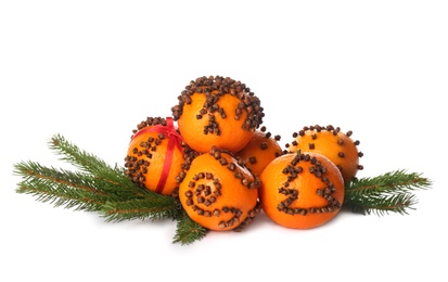 Pile of pomander balls made of fresh tangerines with cloves on white background