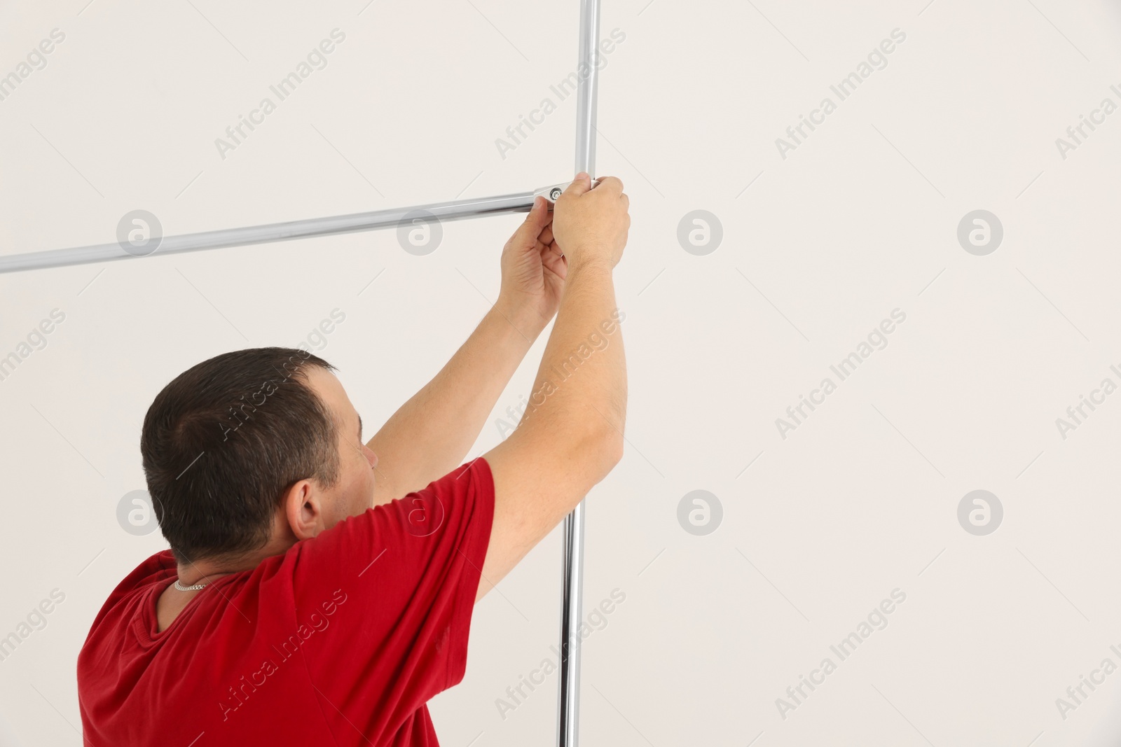 Photo of Worker installing new metal pipes indoors, closeup