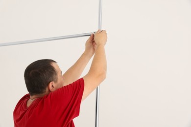 Photo of Worker installing new metal pipes indoors, closeup