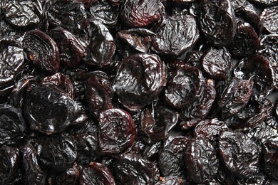 Photo of Tasty prunes as background, top view. Dried fruit as healthy snack