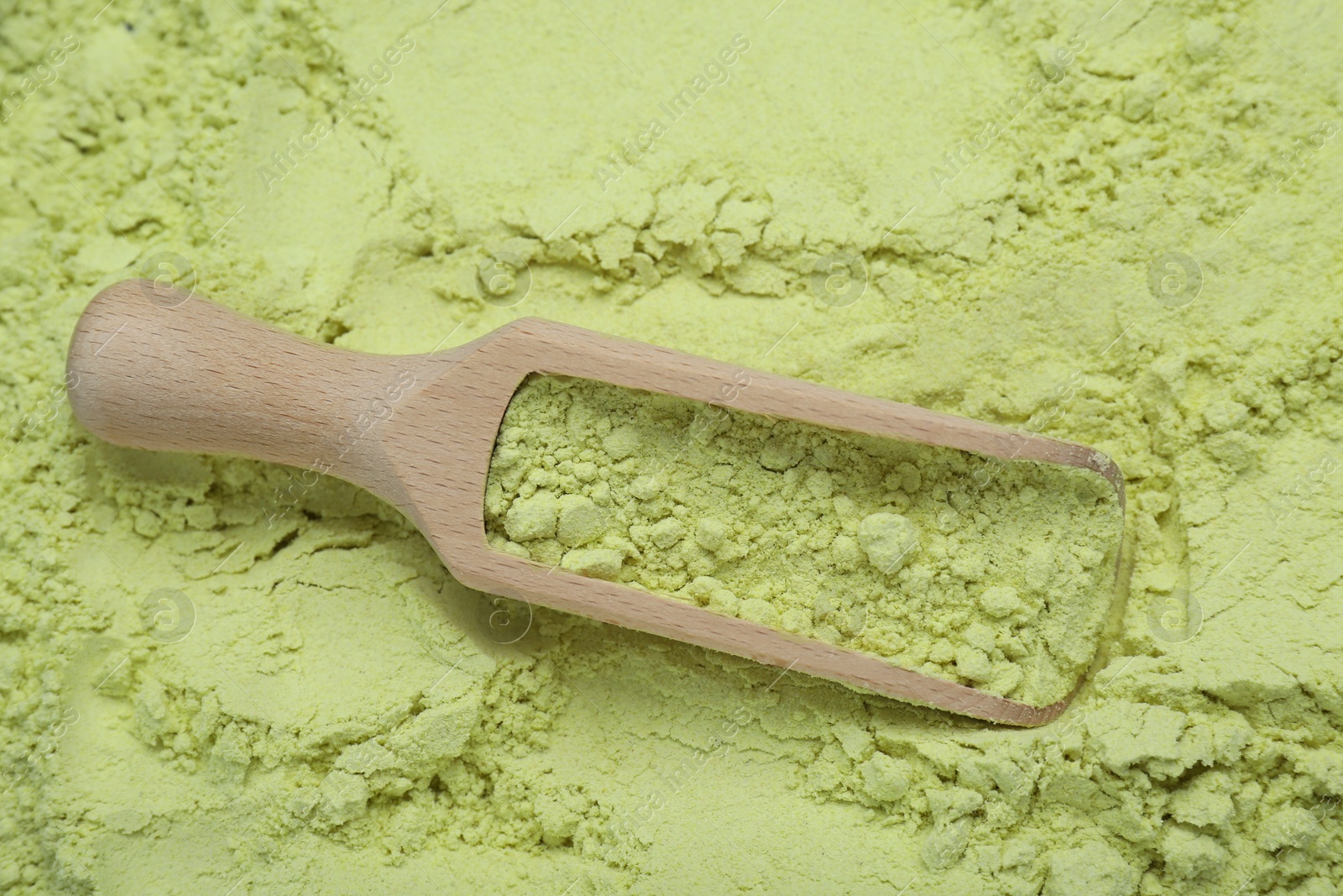 Photo of Natural celery powder and wooden scoop, top view