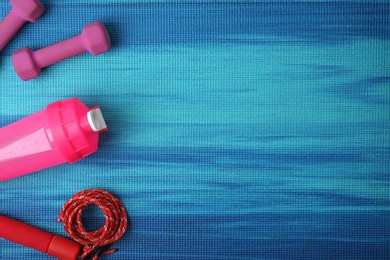 Flat lay composition of sport equipment on color background. Space for text