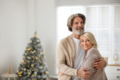 Photo of Happy mature couple celebrating Christmas at home