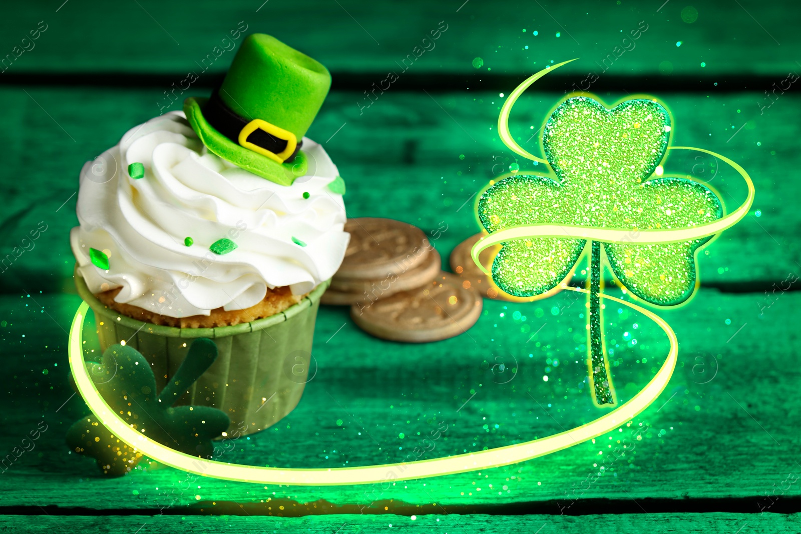 Image of St. Patrick's day party. Tasty cupcake with leprechaun hat topper on green wooden table, closeup. Magical clover leaf near dessert