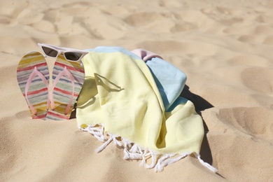 Photo of Stylish beach accessories for summer vacation on sand