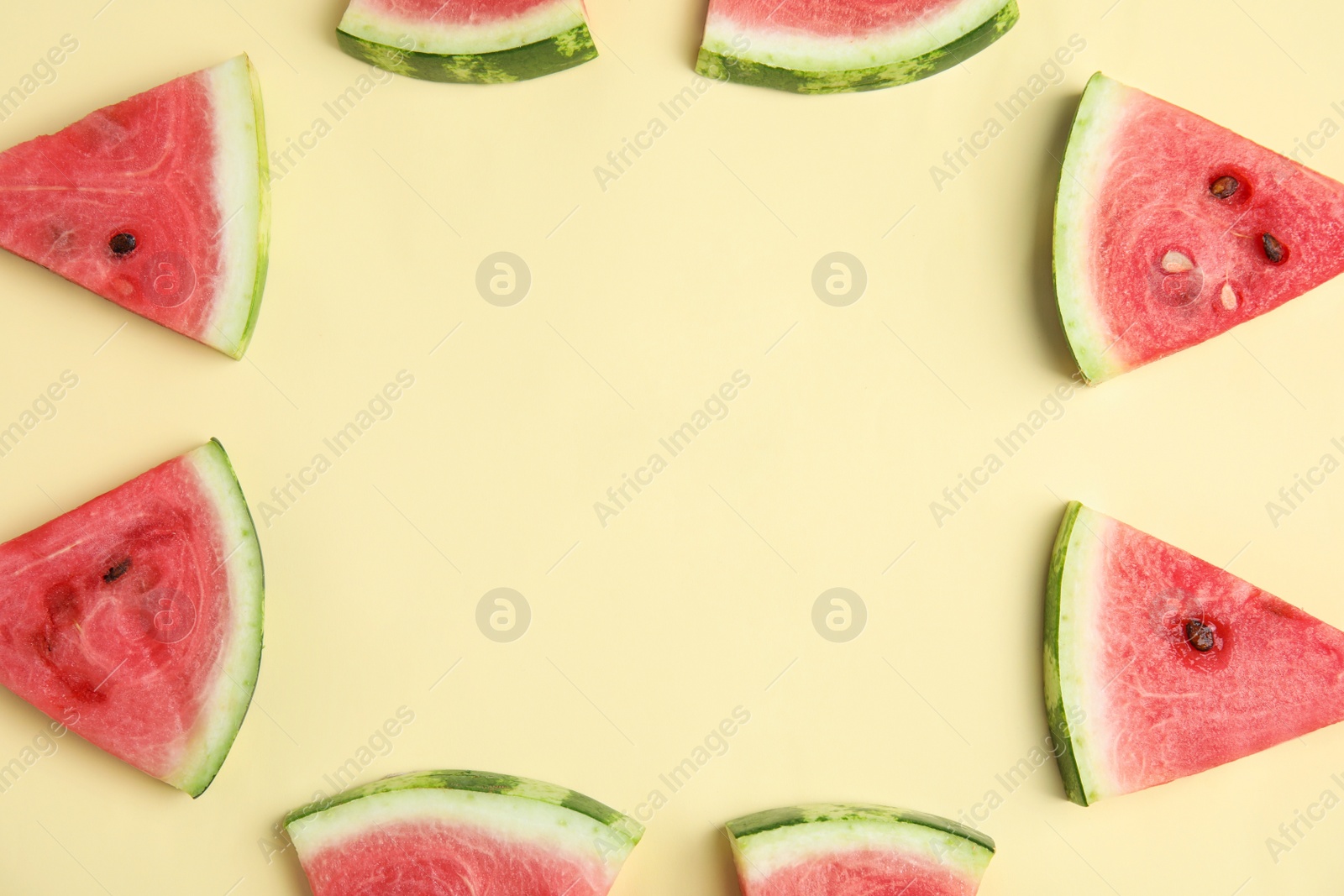 Photo of Frame made with slices of ripe watermelon on beige background, flat lay. Space for text