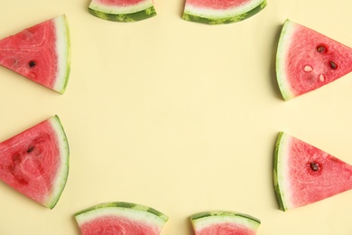 Frame made with slices of ripe watermelon on beige background, flat lay. Space for text