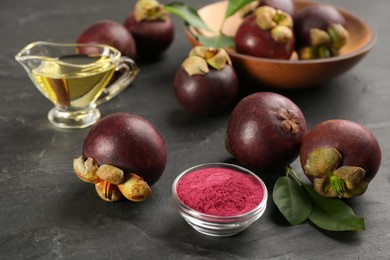 Purple mangosteen powder and fruits on black table