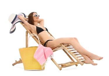 Photo of Young woman with beach accessories on sun lounger against white background
