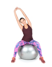 Photo of Young beautiful woman with ball doing exercise on white background. Home fitness