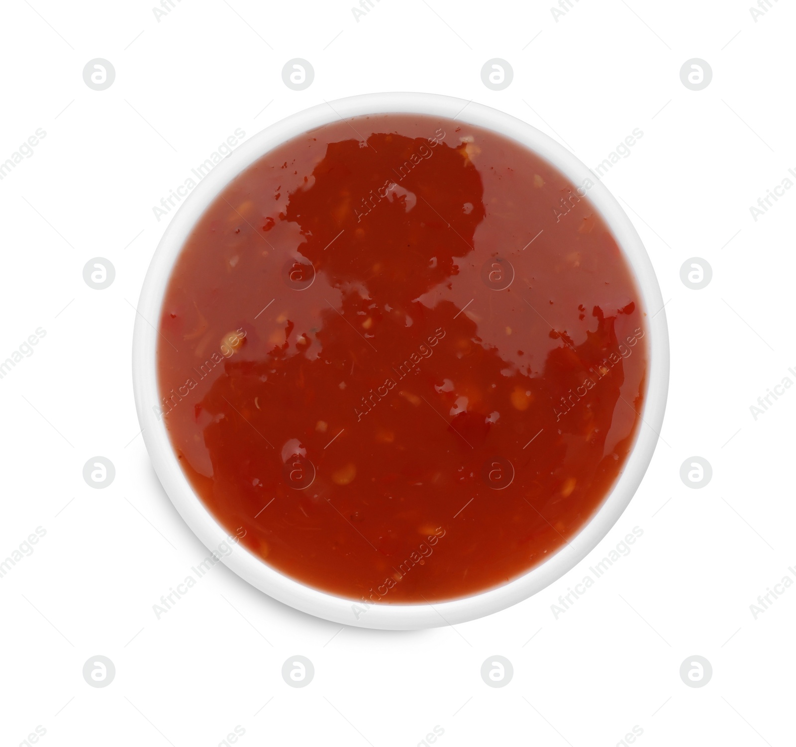 Photo of Tasty chili sauce in bowl isolated on white, top view