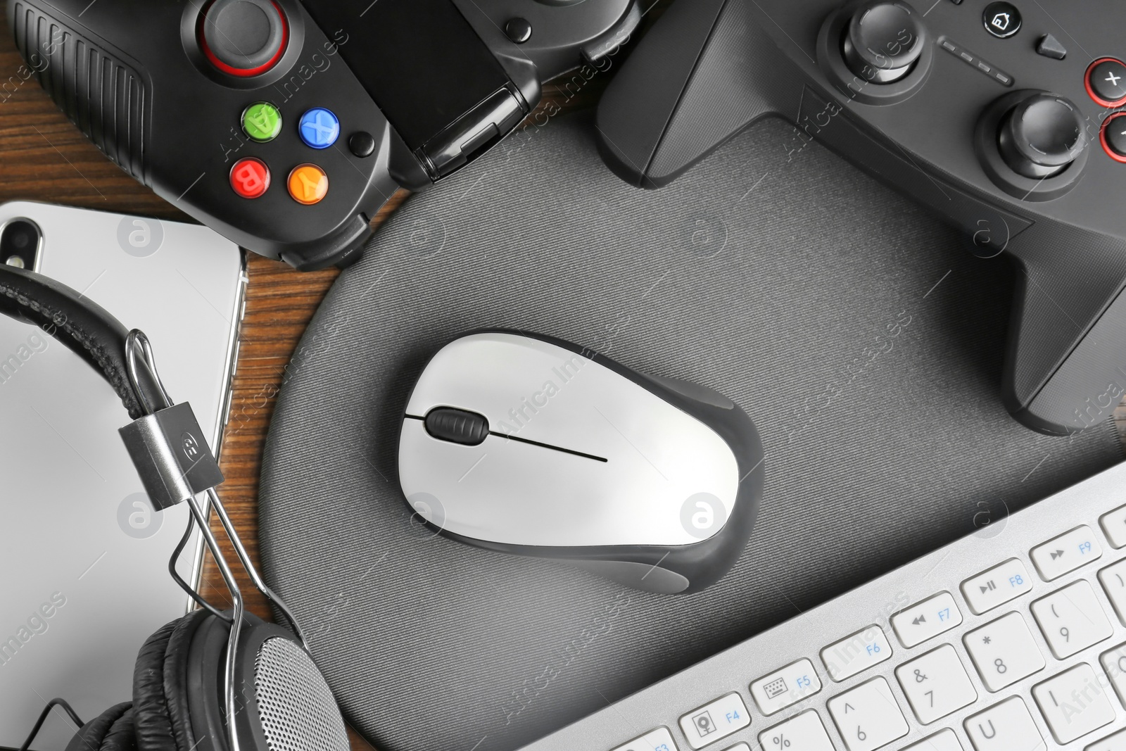 Photo of Flat lay composition with computer mouse and gaming gear on table