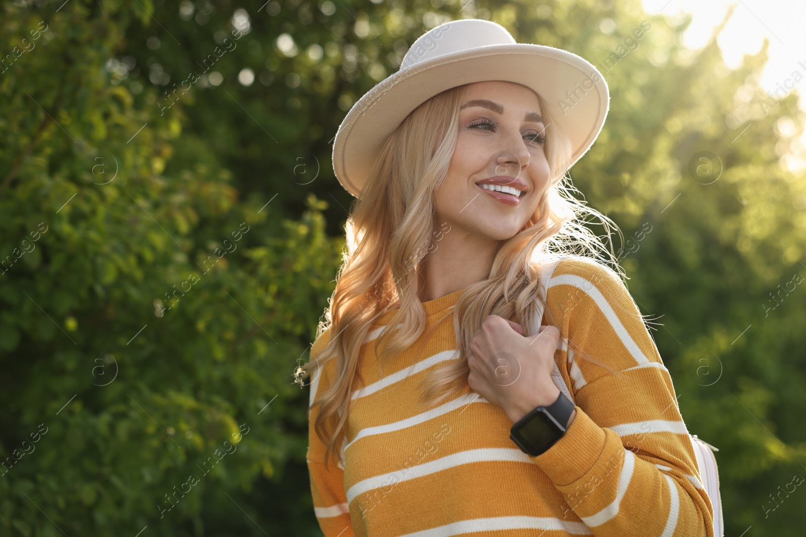 Photo of Portrait of happy young woman in park on spring day