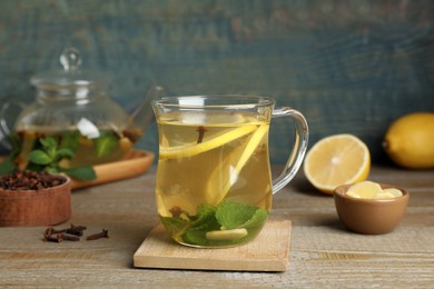 Photo of Glass cup of immunity boosting drink on wooden table