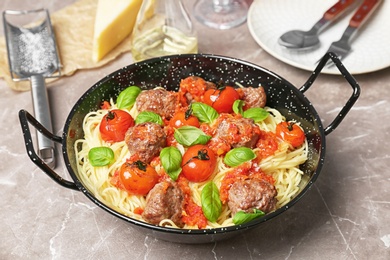 Photo of Pasta with meatballs and tomato sauce on table