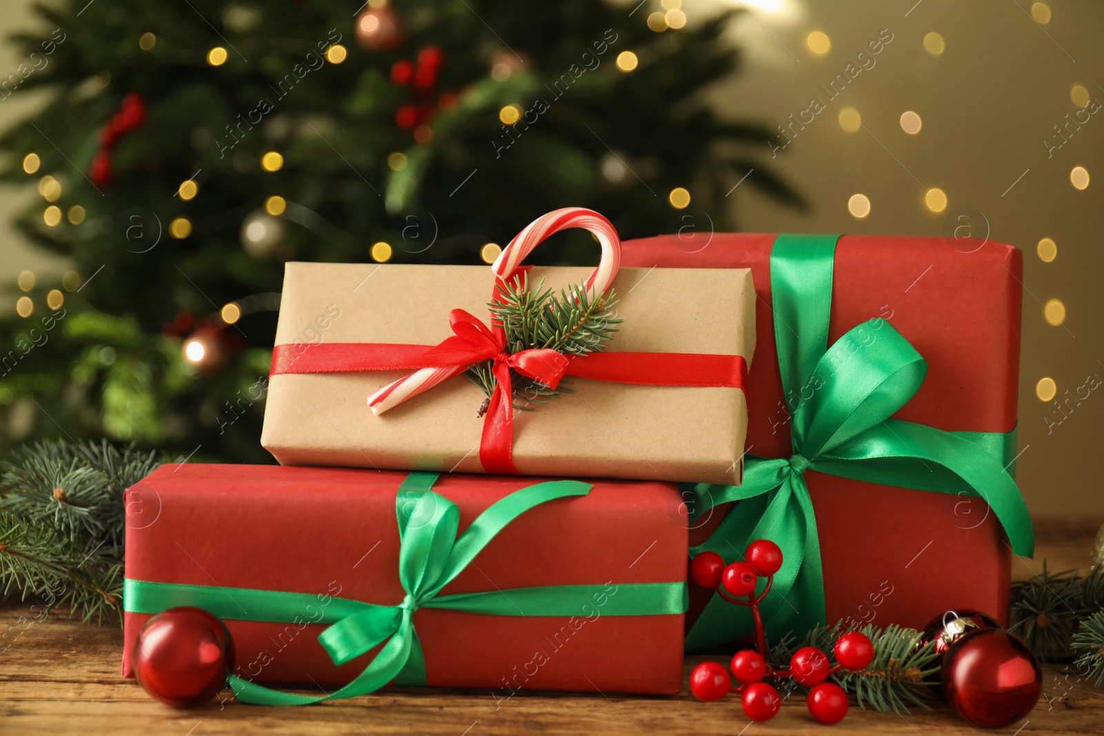 Photo of Beautiful gift boxes and Christmas decor on wooden table, closeup